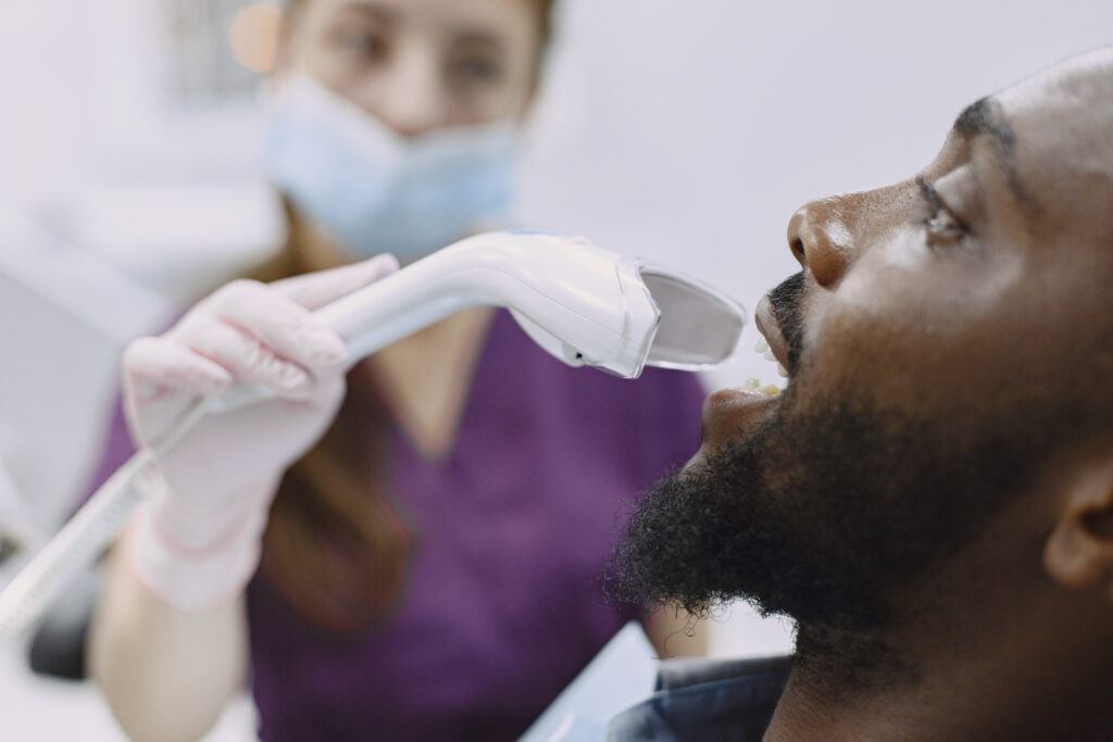 A patient relaxing comfortably while receiving a professional scaling and polishing treatment at a modern dental clinic in Abuja.